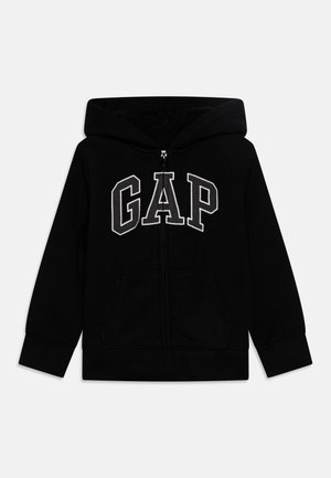 Sweat à capuche noir zippé avec poches avant, doté d'une capuche et d’un large lettrage blanc "GAP" sur la poitrine.
