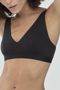 Musta langaton rintaliivi, jossa on syvä v-mallinen kaula-aukko, leveät hihnat ja pehmeä kangas. Ominaisuuksiin kuuluu sileä pinta ja minimalistinen muotoilu ilman näkyvää rautaa.