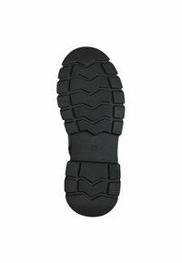 Semelle de chaussure en caoutchouc noir avec un motif de semelle en zigzag, présentant des zones texturées surélevées pour une meilleure adhérence. Taille indiquée : 37.