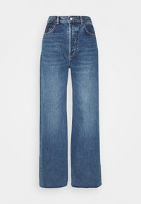 Höga vida jeans gjorda av blå denim. Har kontrasterande sömmar, bältesöglor och en knappstängning. Slät textur med en blekt yta.