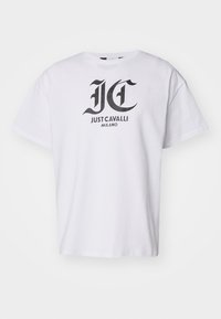 Bílý bavlněný tričko s černým grafickým logem s textem "JC" a "JUST CAVALLI MILANO", krátké rukávy a kulatý výstřih.