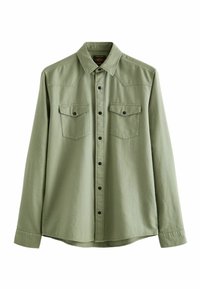 Camicia a maniche lunghe in cotone verde chiaro con chiusura a bottoni, due tasche sul petto e collo a punta. Bottoni neri decorano la parte frontale.