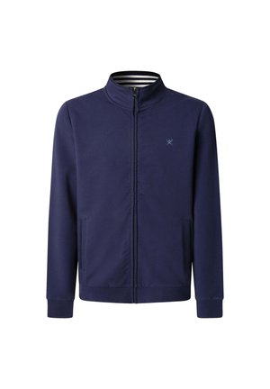 Giacca zip-up blu navy con colletto alto, due tasche laterali e polsini a coste. L'interno presenta un motivo a righe.