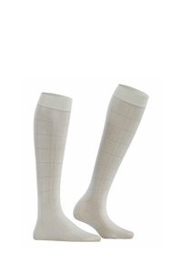 Kniehohe Socken aus leichtem cremefarbenem Stoff mit einem dezenten Karomuster. Glatte Textur und gerippte Bündchen am oberen Ende.