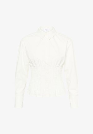 Valge nööbitav särk, millel on kroogitud istuv vöökoht ja pikad varrukad. Sile puuvillane kangas, klassikaline krae ja ees nööbiga kinnis.