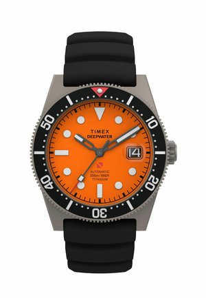 Diver-style watch with orange dial, black rotating bezel, black rubber strap, large white markers, and date window at the 3 o'clock position.