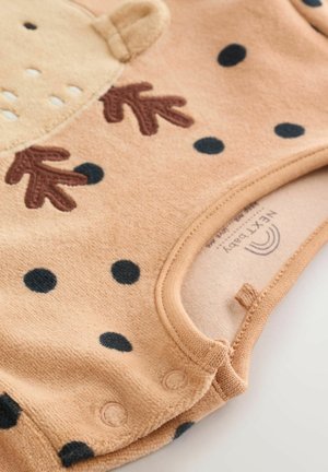 Beiger Baby-Body mit dunkelblauen Punkten, mit einem Bärenkopf-Design, braunen, gestickten Pfoten und Druckknöpfen am Saum. Weicher Stoff.