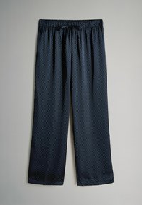Pantalones de pijama azul marino con un patrón de lunares, cintura elástica y cierre de cordón. Tejido ligero con una textura suave.