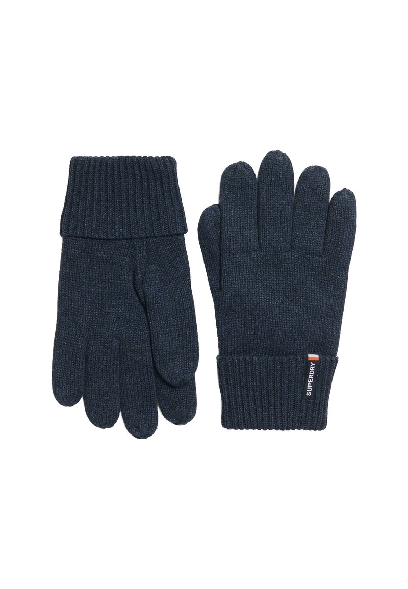 Guantes de punto en azul marino oscuro con puños acanalados. Presentan una textura suave y una etiqueta con logo en la zona de la muñeca. Diseño clásico de cinco dedos.