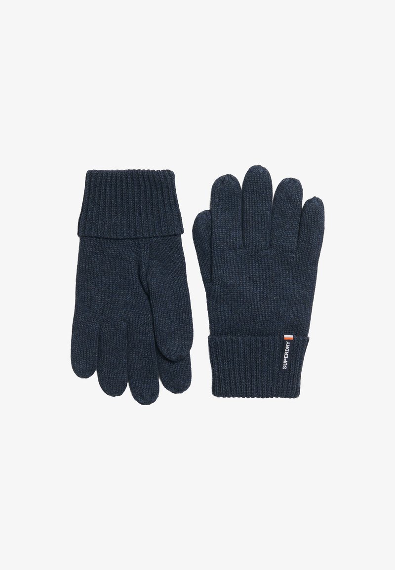Guantes de punto en azul marino oscuro con puños acanalados. Presentan una textura suave y una etiqueta con logo en la zona de la muñeca. Diseño clásico de cinco dedos.