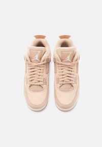 Peach-colored Air Jordan 4 sneakers featuring a textured suede upper, mesh side panels, and signature logo on the tongue and heel.