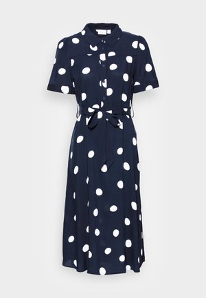 Vestido marinero con lunares blancos, mangas cortas, cuello con solapa, cintura ajustable y una silueta fluida. Tela suave con un corte relajado.