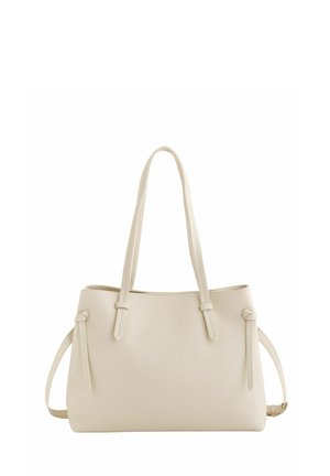 Sac fourre-tout en cuir couleur crème avec deux longues anses et des brides latérales, présentant un design simple et lisse.