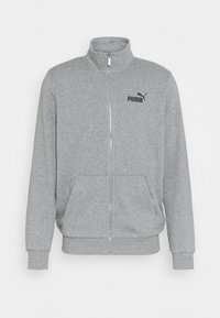 Světle šedá zipová bunda z měkkého materiálu, s vysokým límcem, dvěma předními kapsami a černým logem Puma na horní levé straně.