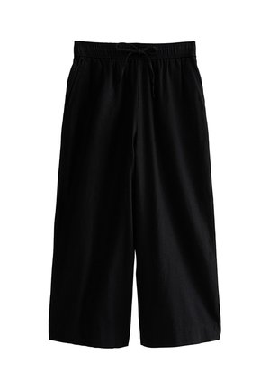 Zwarte, wijde cropped broek met elastische tailleband en aantrekkoord, voorzien van zijzakken.