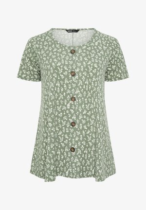 Vihreä lyhythihainen pusero pyöreällä pääntiellä, valkoisella kukkakuvioinnilla ja viidellä ruskealla napilla etuosan keskellä.