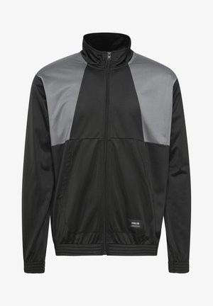 Fekete cipzáras dzseki szürke panel részletekkel, magas gallérral és elasztikus mandzsettákkal. Simakönnyű anyagból készült, és két oldalsó zseb található rajta.