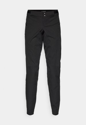 Čierne technické nohavice so slim fit strihom, odolným materiálom, viditeľnými detailmi šitia a dvoma bočnými vreckami na zips.