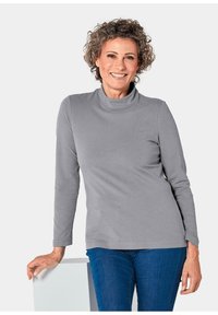 Grijze turtleneck shirt met lange mouwen, gemaakt van zachte stof, met een relaxte pasvorm en subtiele decolleté, gecombineerd met blauwe jeans.