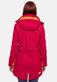 Pink outdoor jacket with orange interior lining, adjustable hood, belted waist, and logo detail. Features smooth texture and structured design.