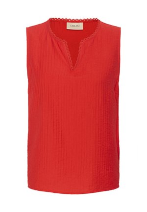 Punane ilma varrukateta topp, mis on valmistatud kortsusest kangast, millel on V-kaelus ja lainelise äärisega kaelus. Lihtne ja kerge disain.