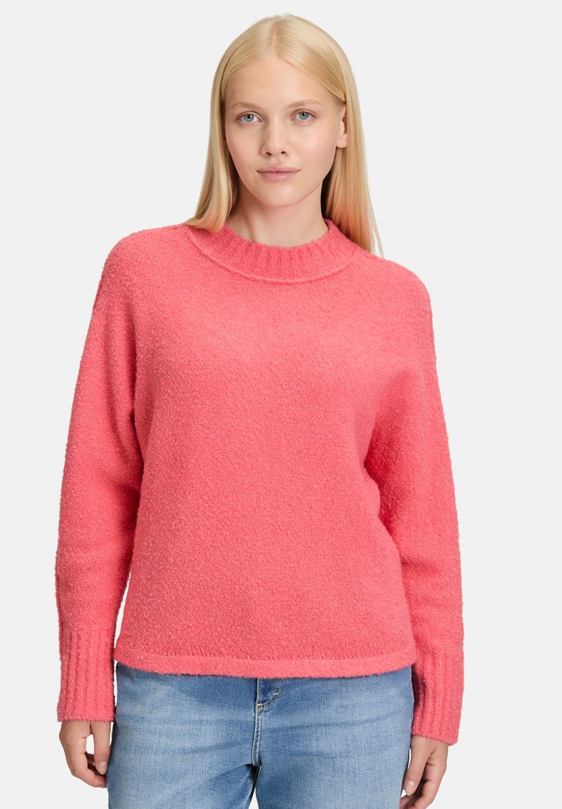 Heldere roze trui met een textuurafwerking, geribde halslijn en lange mouwen. In combinatie met denim heeft het een relaxte pasvorm.