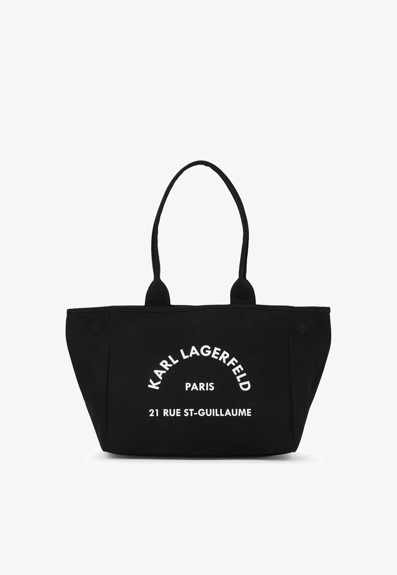 Черна чанта с две дръжки, изработена от канвас, с бял текст: "KARL LAGERFELD PARIS 21 RUE ST-GUILLAUME." Приблизителна правоъгълна форма.