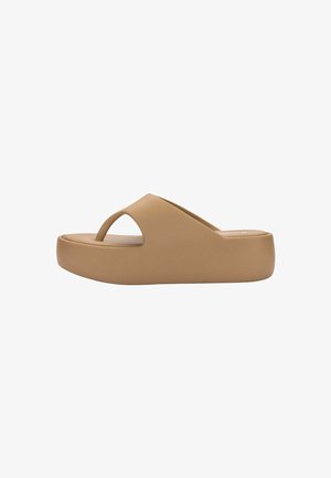 Beige platform flip-flop sandal with thick sole and wide upper strap, designed for casual wear.