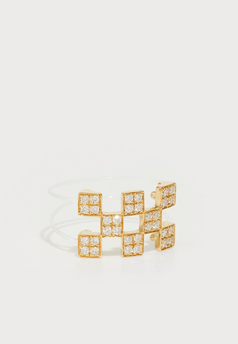 Gold-colored ring featuring a geometric design with clear gemstones arranged in squares, on a translucent band. Smooth texture.