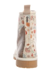 Ankle boot with a cream synthetic upper, featuring colorful leaf and mushroom patterns, a rear pull tab, and a rubber sole.