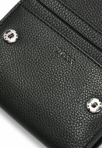 Black leather wallet with a pebbled texture, featuring silver hardware, embossed logo, and multiple credit card slots.