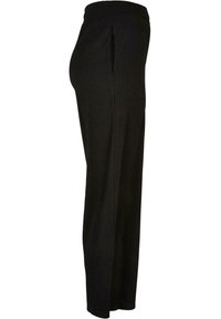 Pantalon noir côtelé avec une taille élastique, équipé de poches latérales et d'une coupe droite. Texture douce et coupe ample pour le confort.