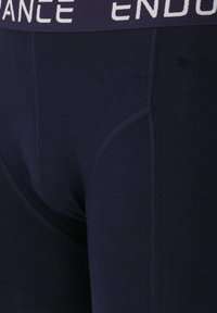 Navy blue boxer briefs made of soft fabric, featuring a wide elastic waistband with "ENDURANCE" in white text, and seamless stitching details.
