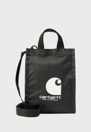 Mustast riidest kandekott lühikeste ülemiste käepidemete ja eemaldatava õlarihmaga. Esiküljel on suur valge Carharti logo.