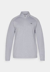 Lys grå genser med kvart glidelås, lange ermer og en subtil logo. Laget av et mykt, teksturert stoff.