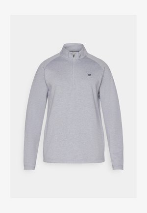 Gai pelēkās krāsas džemperis ar ceturtdaļas rāvējslēdzēju, garām piedurknēm un diskrētu logotipu. Izgatavots no mīksta, teksturēta auduma.