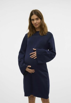 Tumesinine kudumine raseduskleit pikka, laia varruka ja ümmarguse kaelusega. Keha lähedane lõige sisaldab kogumise ala kõhu jaoks.