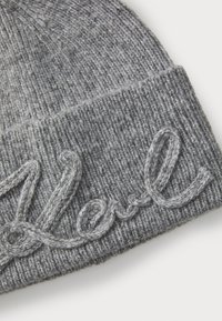 Gray knit beanie with a ribbed texture. Features an embroidered "Karl" in a matching gray thread across the front.