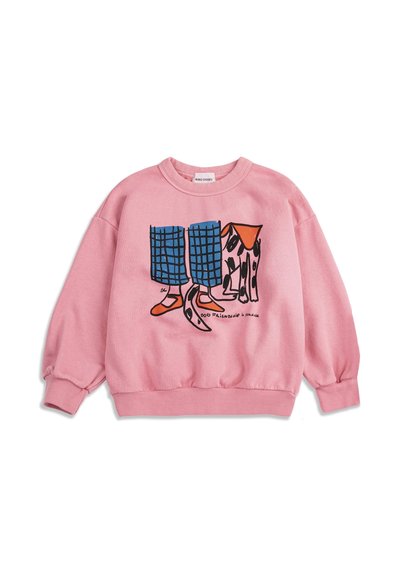 Sweat-shirt rose avec une illustration d'un pantalon à carreaux bleu, des chaussures orange et un chien tacheté debout côte à côte, le texte indique "Amitié canine."