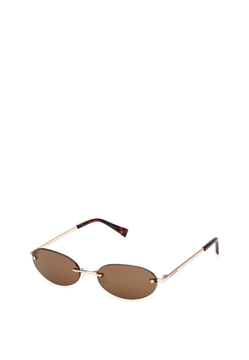 Brune ovale solbriller med en guldfarvet metalramme. Stængerne har et skildpaddemønster og små stjerneaccenter på linserne.