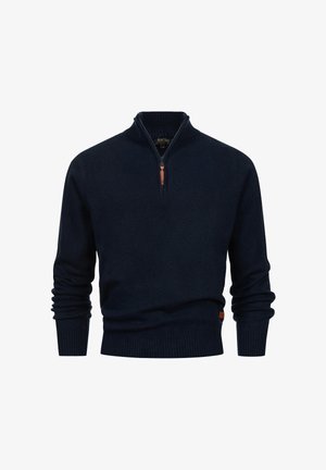 Suéter de punto azul marino con cuello con cremallera, puños acanalados y un pequeño detalle de logo de cuero en el dobladillo. Textura suave y ajuste regular.