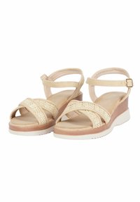 Sandali wedge beige con fasce intrecciate e suola interna liscia. Cinturino alla caviglia regolabile e suola in gomma bianca con trazione.