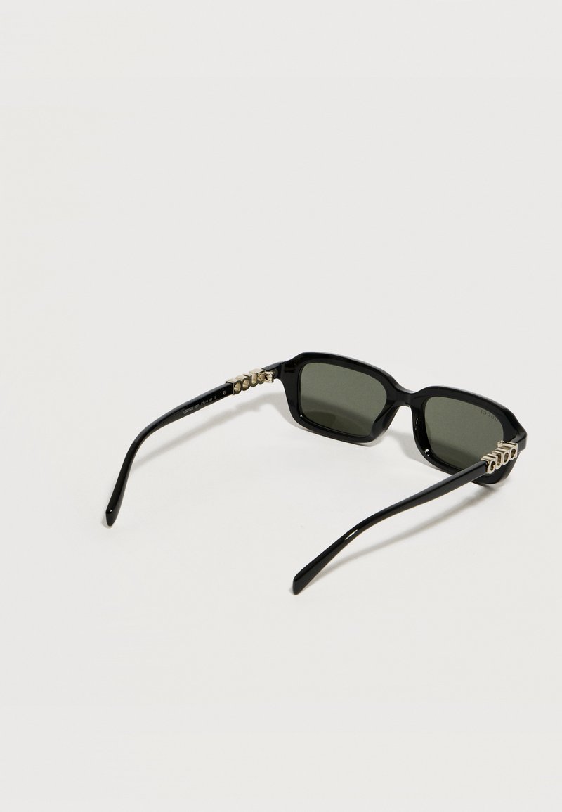 Black rectangular sunglasses with dark lenses and a gold chain detail on both temples, displayed on a light background.