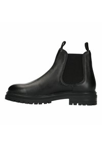 Bottine Chelsea en cuir noir avec panneau élastique texturé sur le côté, tirette et semelle robuste. Fini lisse et design à bout rond.