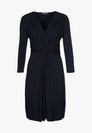 Vestido negro hasta la rodilla con mangas largas, escote en V y detalle anudado en la cintura que crea un efecto de tela fruncida.