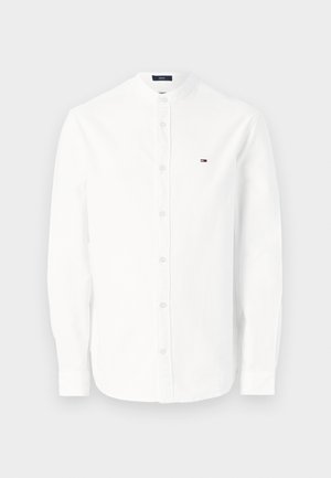 White long-sleeve shirt with a pointed collar, button-down front, and small logo detail on the left chest. Made from a smooth fabric.