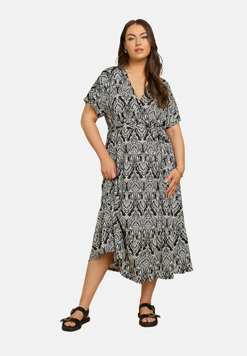 Czarna i biała wzorzysta sukienka w stylu wrap z krótkimi rękawami, wiązaniem w talii i rozkloszowanym dołem. Posiada misternie wykonany wzór damask.