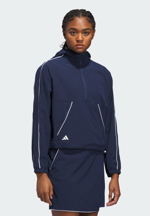 Granatowa sportowa kurtka z półzamkiem, prążkowaną fakturą, białymi akcentami i elastycznymi mankietami. Posiada kołnierz z ćwiartkowym zamkiem błyskawicznym oraz boczne kieszenie.