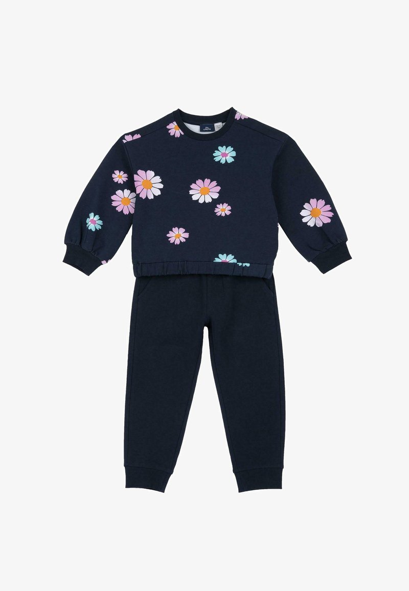 Sweatshirt et pantalon de sport bleu marine avec des motifs floraux en rose, blanc et turquoise. Comprend un col rond et des poignets élastiques sur le sweat et le pantalon.