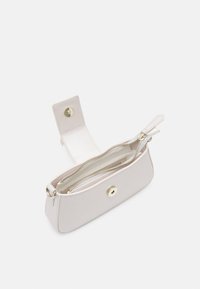 Světle béžová kabelka na vyjímaní s hladkou texturou, zlatými kovovými prvky, zipovými kapsami a klopou se západkou.